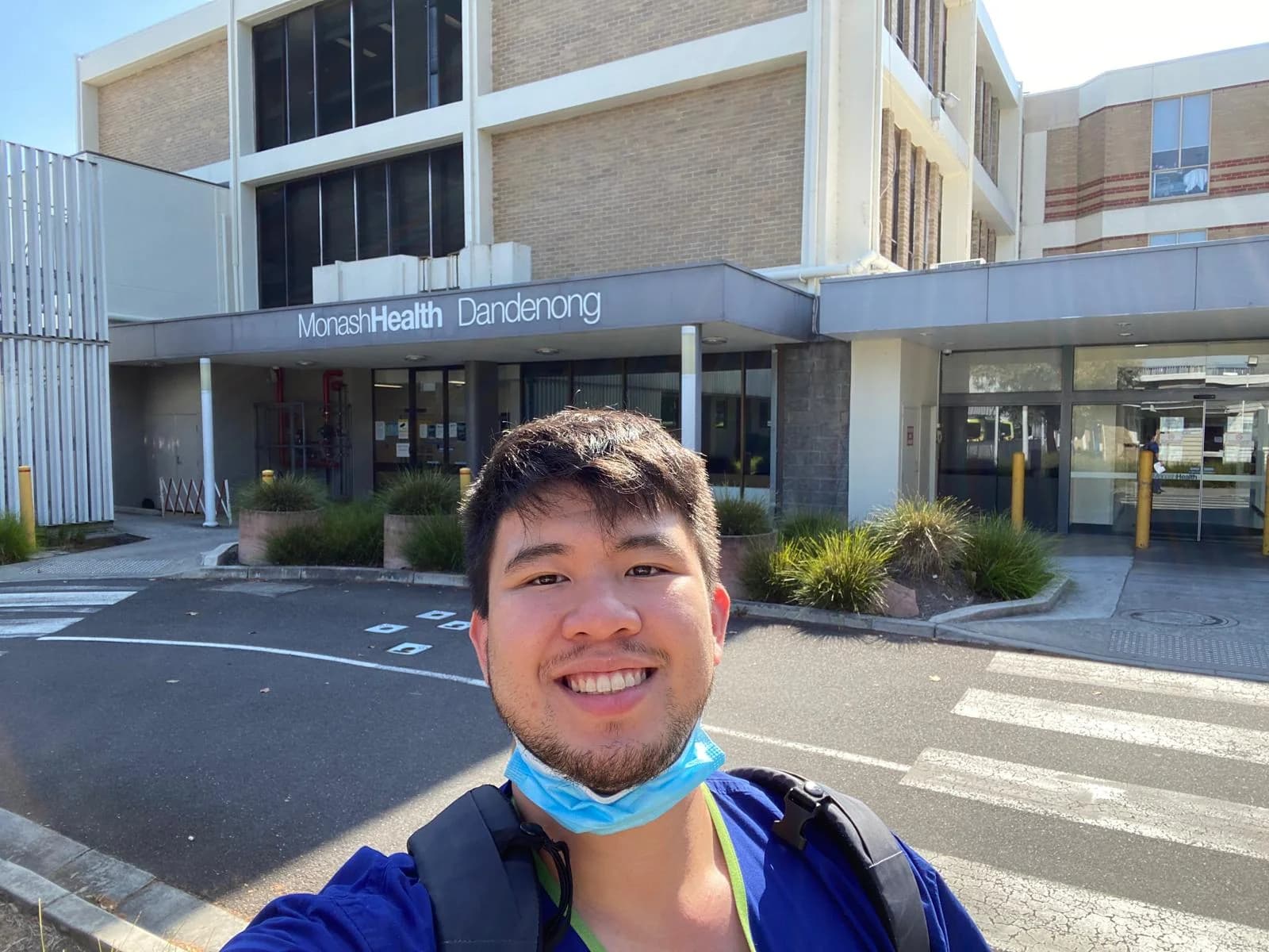 Dr Joshua Ho in scrubs outside Monash Health Dandenong Hospital